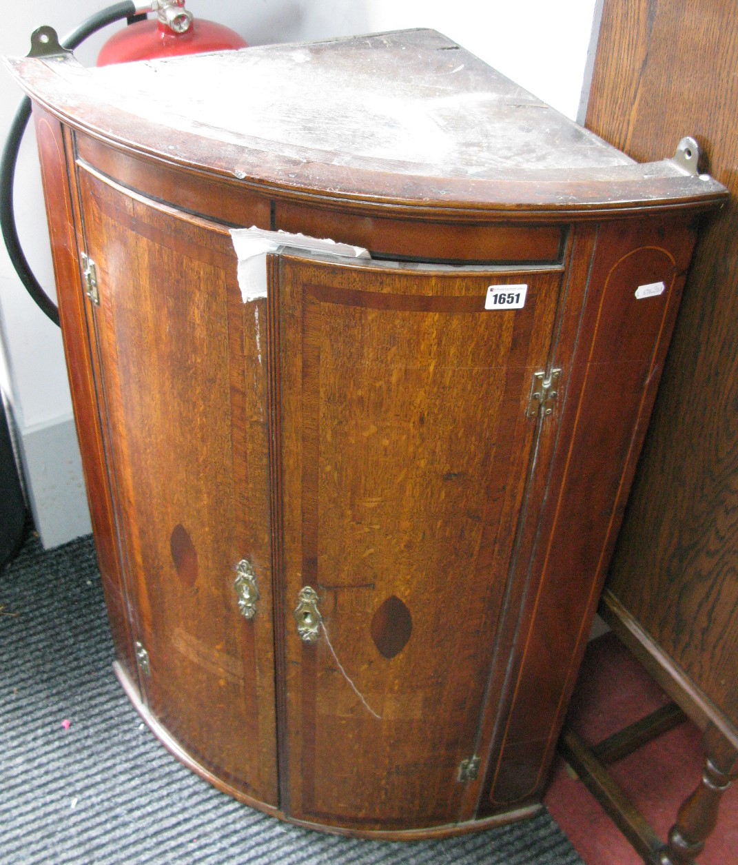 A XVIII Century Oak Bow Fronted Corner Cupboard, with mahogany and boxwood strip inlay, three