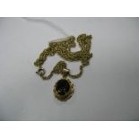 A 9ct Gold Single Stone Pendant, collet set, on a chain.