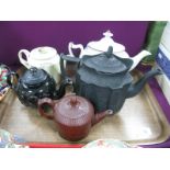 An XVIII Century Leeds Creamware Teapot, with intertwined handles (damages), black glazed Jackfield