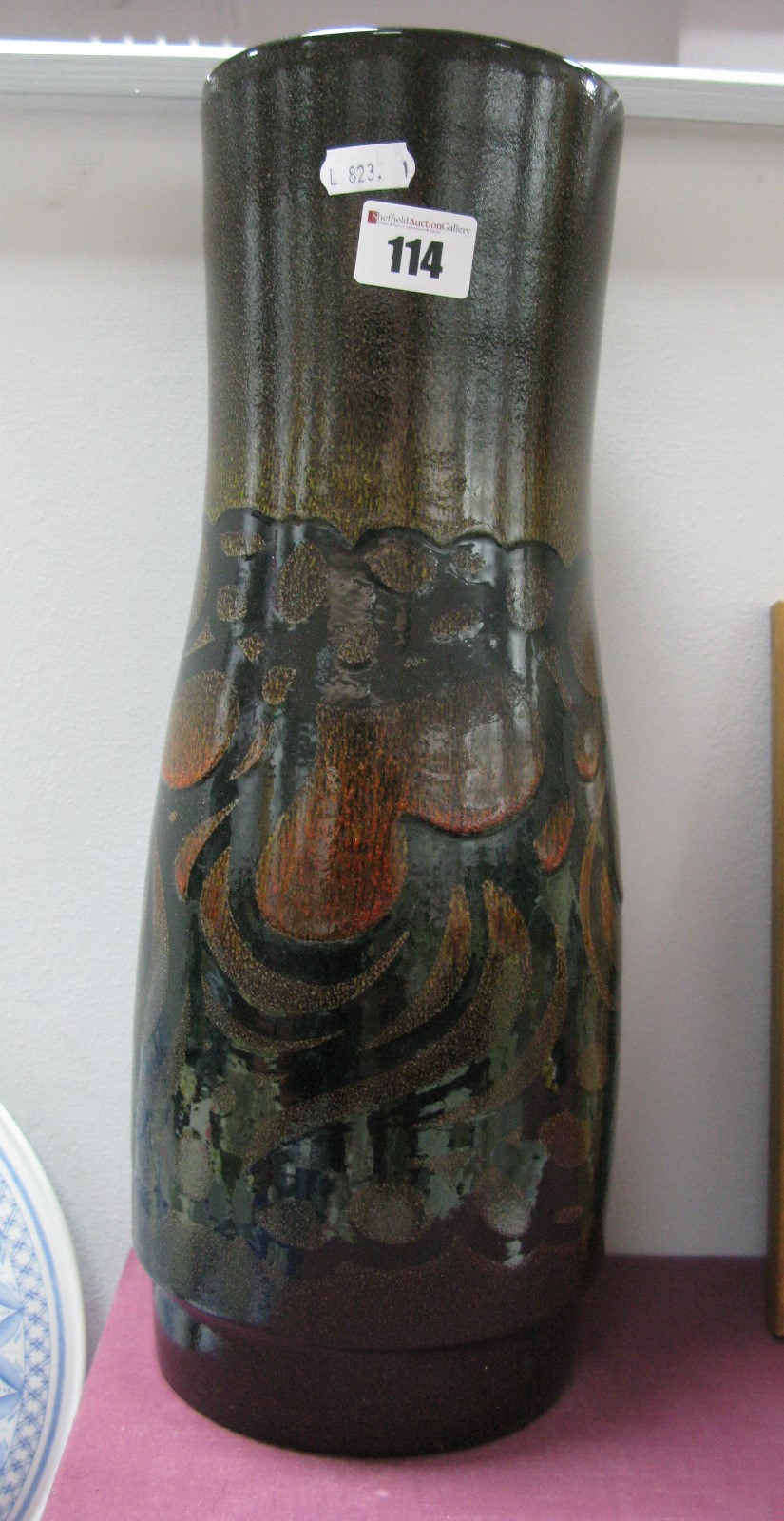 Poole Pottery Aegean Vase, of waisted form, on deep brown form, 40cm tall, on deep brown ground.