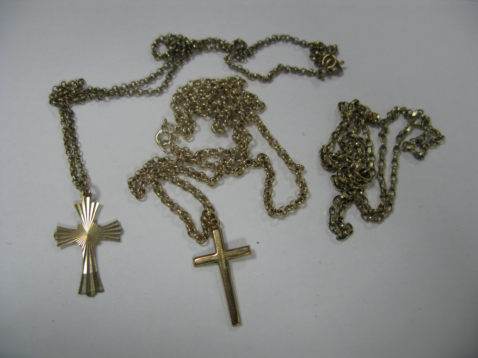 Two 9ct Gold Cross Pendants, on 9ct gold chain; together with another 9ct gold chain.