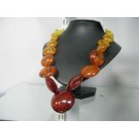 A Modern Amber Coloured Bead Necklace of graduated design, to screw clasp.