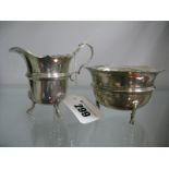 A Matched Hallmarked Silver Jug and Sugar Bowl, each with wavy cut edge, raised on three pad