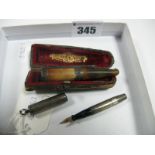 A Miniature Fountain Pen, '14 KT' nib, engine turned case stamped 'STERLING', length 6.4cm, and a