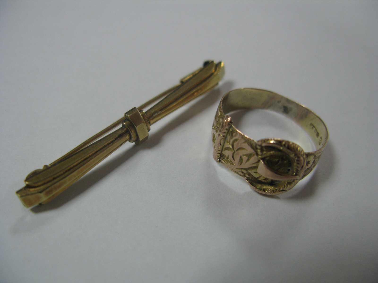 A 9ct Gold Ring, of belt buckle design; together with a small Art Deco style bar brooch, stamped "