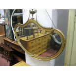 A Kidney Shaped Bevelled Wall Mirror, in gilt wood frame with wave cresting.