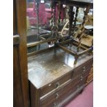 An Oak Three Heights Dressing Chest, with two short and two long drawers, tapering legs.