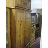 Pine Wardrobe, with upper cupboard doors, panelled doors over two long drawers; together with a