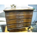 An XX Century Indian Hardwood Chest of Drawers, with a hinged top, fitted interior, three carved