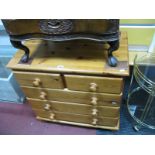 A Pine Chest of Drawers, with two short and three long drawers, on bun feet.