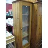 A Pine Narrow Display Cabinet, central glazed door with internal shelving, over two short drawers.