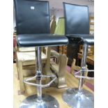 A Pair of Adjustable Chrome Based Bar Chairs.