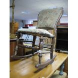 A Late XIX Century Rocking Chair, with upholstered back and seat, on turned legs on rockers.