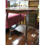 An Edwardian Inlaid Mahogany Occasional Table, with shaped undershelf united by sabre legs.