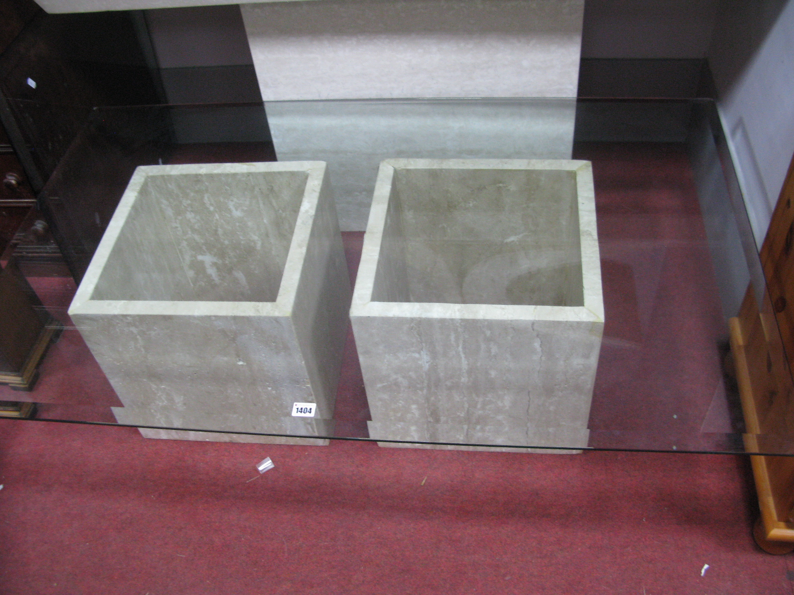 A Marble Based Coffee Table, with twin pedestals and glass top.