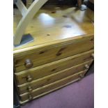 A Pine Chest of Drawers, with four long drawers, on bun feet.