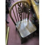 A Set of Four Hoop Back Dining Chairs, each with wheel pierced centre splat.