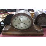 A 1920's Oak Mantel Clock, with an oval dial, stepped base.