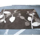 Aura 100% Wool Pile Rug, with floral decoration on brown ground, 240 x 170cm.