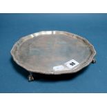 A Hallmarked Silver Waiter, T.B, London 1905, of shaped circular form, raised on four ball and