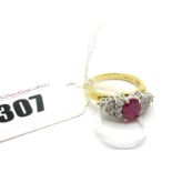 An 18ct Gold Ruby and Diamond Set Ring, oval four claw set to the centre with an (8x6mm) oval