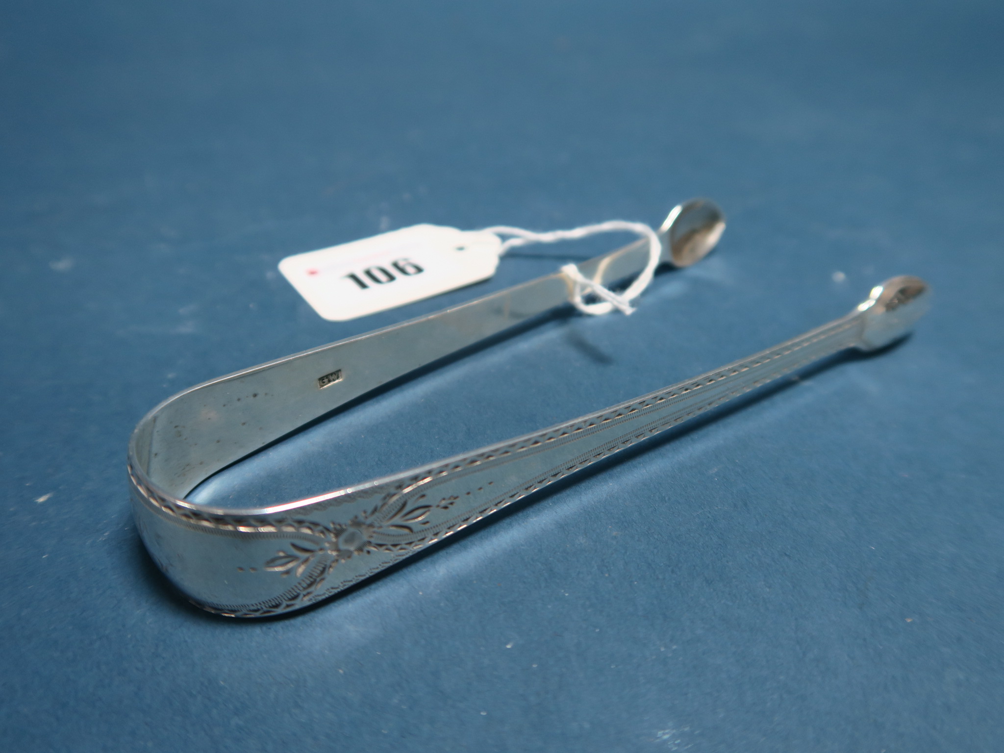 A Pair of Hallmarked Silver Sugar Tongs, GW, London 1831, with bright cut engraved decoration,