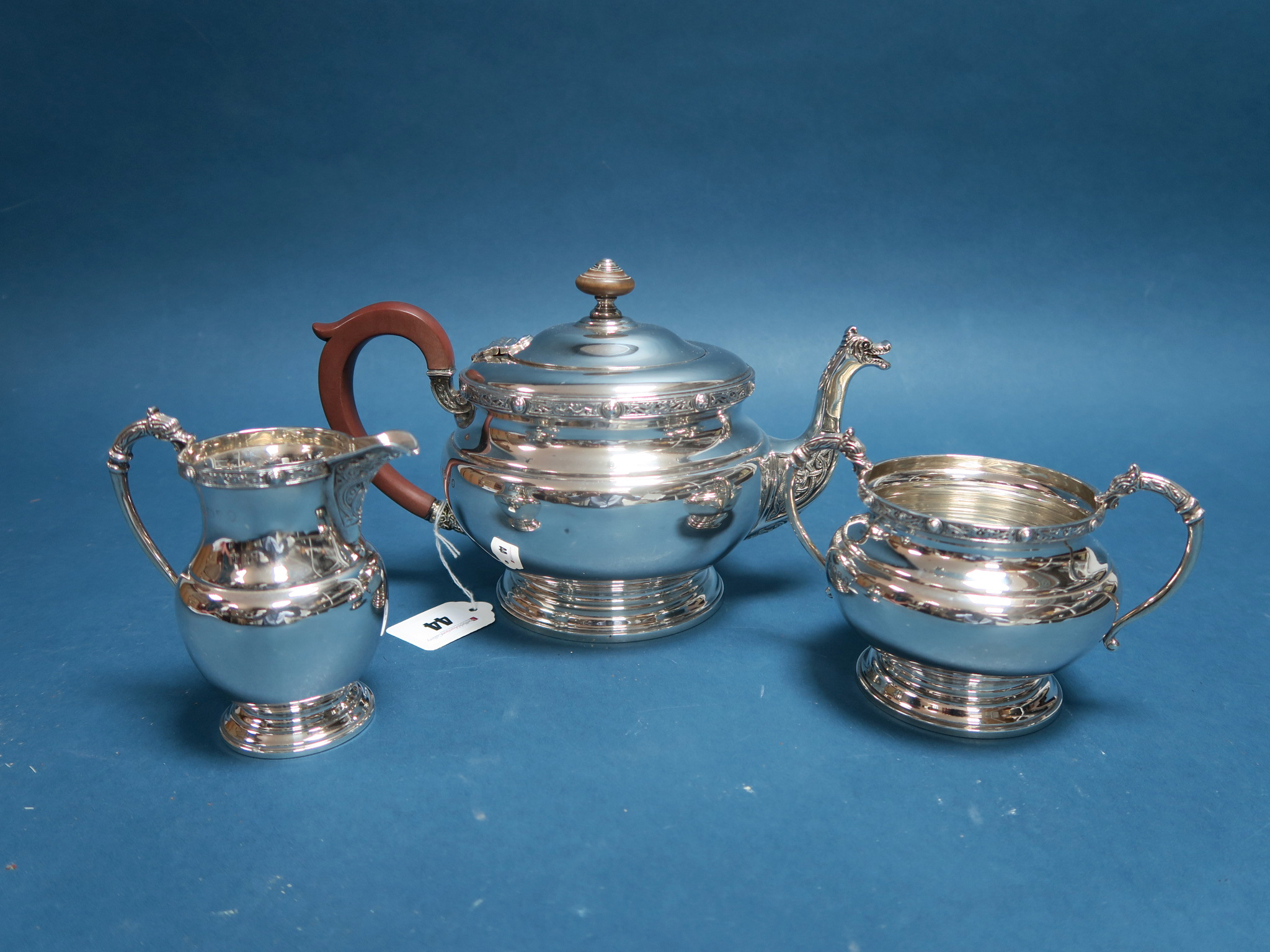 A Hallmarked Silver Three Piece Tea Set, Adie Bros, Birmingham 1935, each with Celtic band style