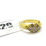A Modern 18ct Gold Princess Cut Diamond Set Ring, collet rubover graduated offset, between plain