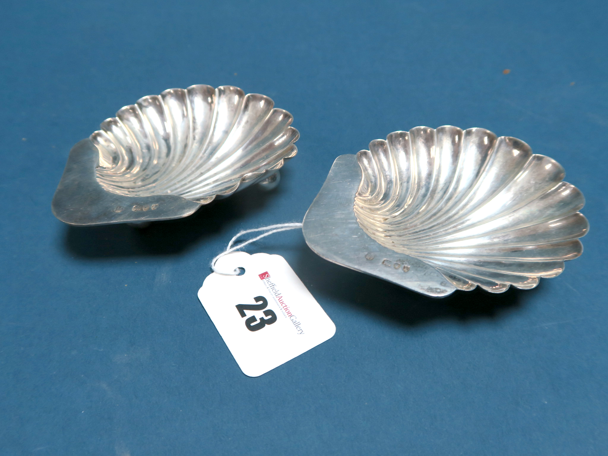 A Pair of Hallmarked Silver Shell Dishes, E.F.HT, London 1893, each raised on three ball feet. (2)