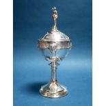 An Arts & Crafts Style Lidded Trophy Cup and Cover, detailed with wild animal masks, the circular