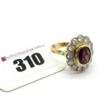 A Large 18ct Gold Ruby and Diamond Cluster Ring, oval collet rubover set to the centre with an (