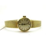 Omega; A Ladies Wristwatch, the signed circular dial with baton makers, inside case stamped "18K 0.