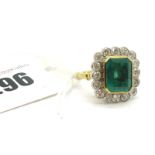 A Large 18ct Gold Emerald and Diamond Cluster Ring, the central (12x10mm) emerald cut emerald collet