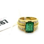 A Large Emerald and Diamond Set Dress Ring, the large (11x8.5mm) emerald corner set between wide