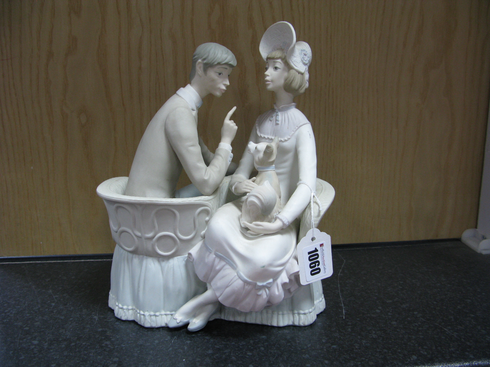 Lladro Pottery Figure Group, unglazed, featuring seated courting couple with dog, 26cm high.