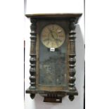 A XIX Century Walnut Vienna Wall Clock, with applied top, glazed door, circular dial, Roman