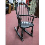 A Victorian Painted Elm Child's Windsor Rocking Chair, on ring turned supports and legs.