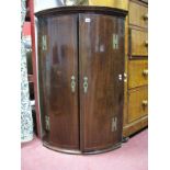 An XVIII Century Mahogany Bow Fronted Corner Cupboard, with brass 'H' hinges, inlaid doors three