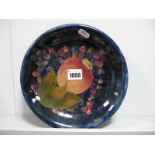 A Moorcroft Pottery Dish, of shallow circular form, painted in the "Pomegranate" pattern against