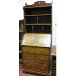 An Edwardian Mahogany Bureau, with spindle supports to open shelves over fall front, carved BJG