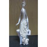 Lladro Pottery Figure, lady holding closed parasol with dog, 34.5cm high.