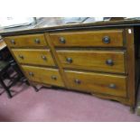 An Early XX Century Walnut Chest, with two banks of three drawers, on turned legs, 137cm wide.