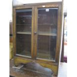 An Early XX Century Oak Cabinet, with a three quarter gallery back, glazed doors on bracket feet.