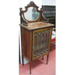 An Edwardian Mahogany Inlaid Cabinet, with a three-quarter gallery back, with central mirror with