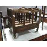 A XIX Century Mahogany Canterbury, with a shaped carrying handle, rail supports, single drawer, on