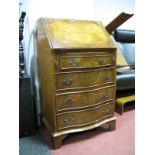 A XX Century Walnut Bureau, with a crossbanded top and fall, fitted interior, four serpentine shaped