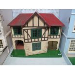 A Mid XX Century Tri-ang Dolls House, single opening front. A quantity of associated furniture,
