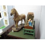 An Early XX Century Animal Skin Toy Horse on Wheels, length 53cm, height 58cm, width 22cm.