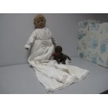An Early XX Century Felt Doll, 19" high, glass eyes, centre seam down face, white dress, together