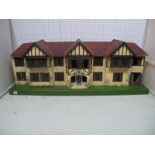 A Large Pre War Tri-ang Dolls House, in mock Tudor style, with electric lighting, four front opening
